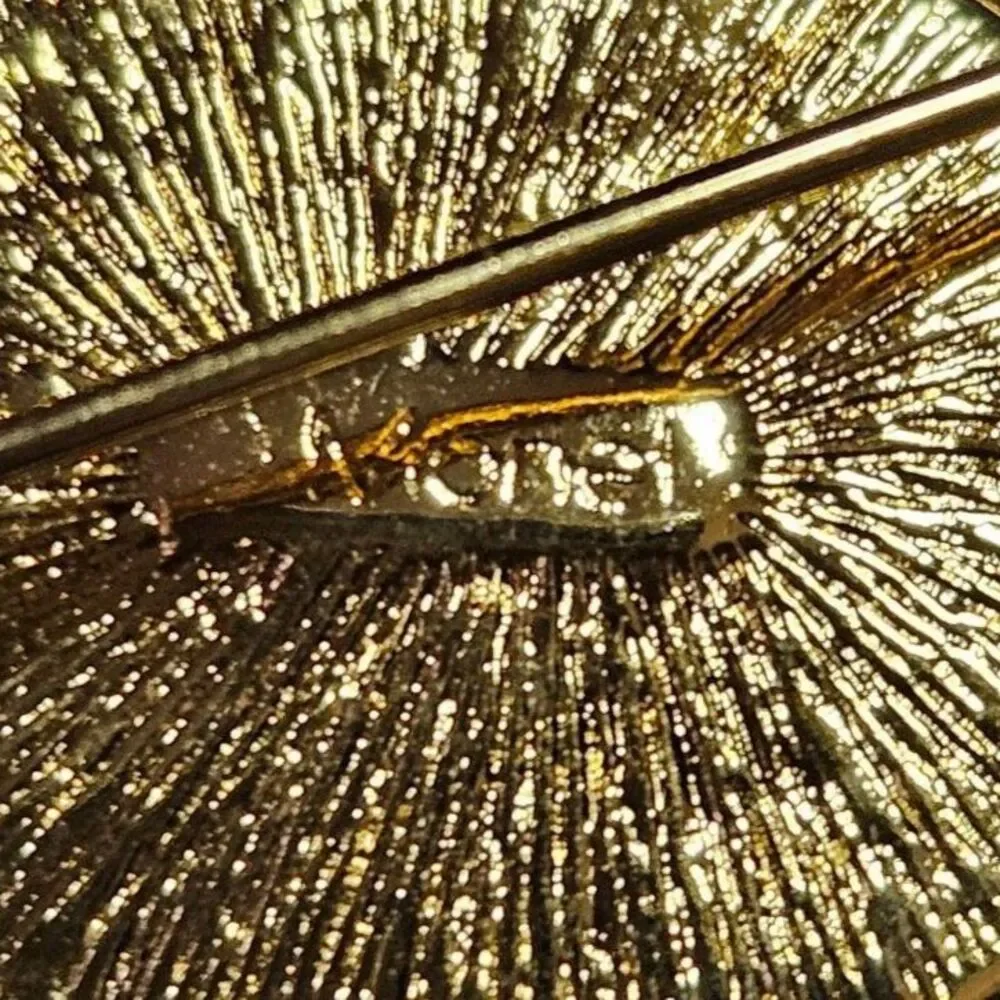 Vintage Monet gold tone swirl brooch